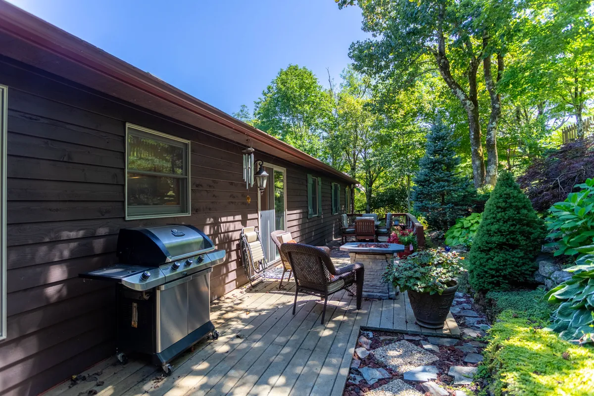 The image highlights an inviting outdoor seating area with a grill, landscaped garden, and a pathway. The space is ideal for barbecuing, relaxing, and socializing, embodying the spirit of family togetherness and outdoor play referenced in the section.